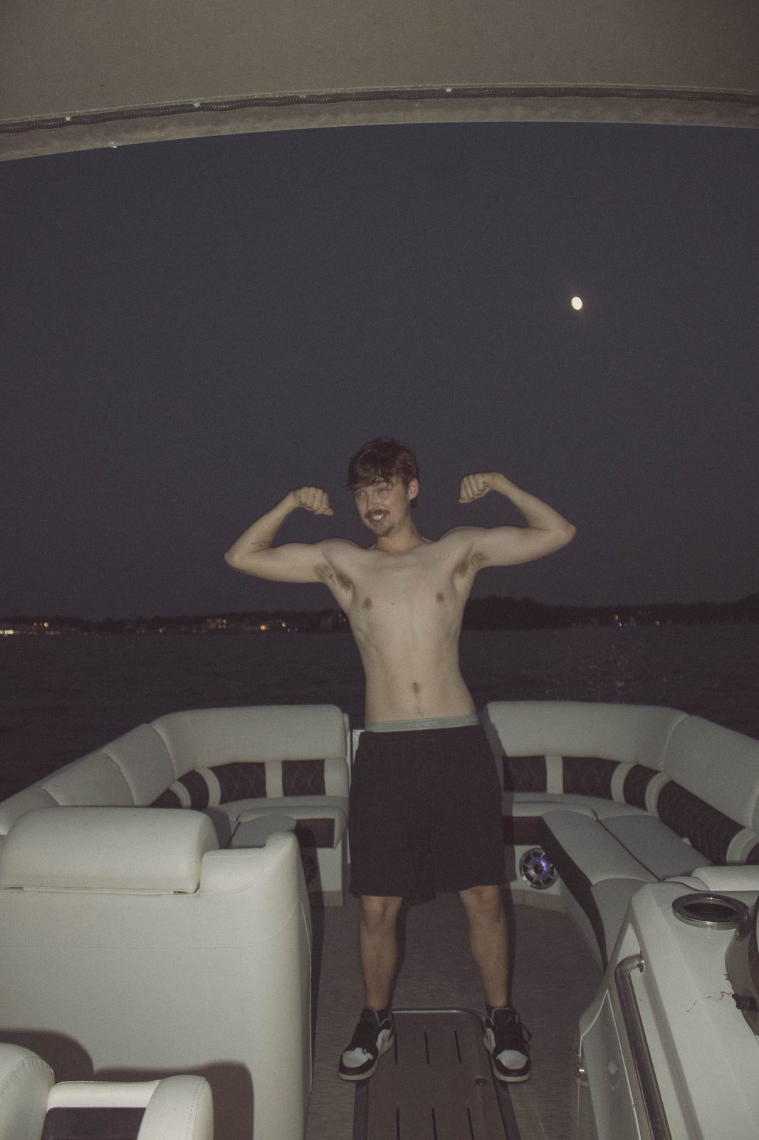 04Riley flexing on the pontoon under the moon