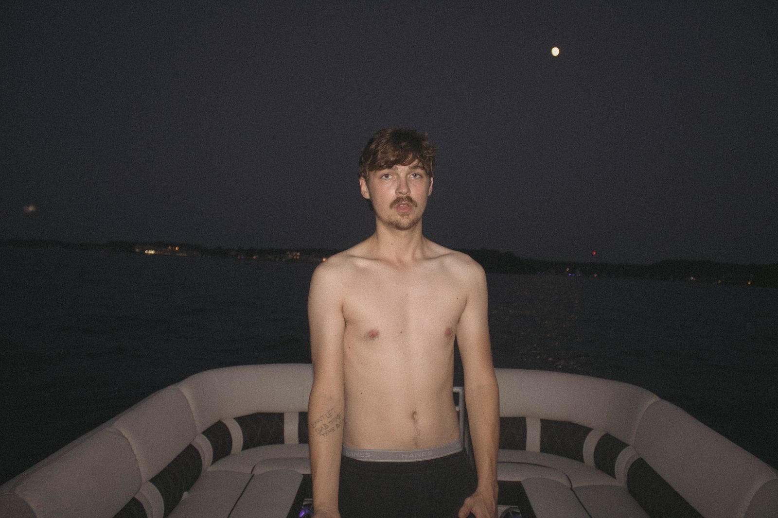 04Riley on the bow of the pontoon at night