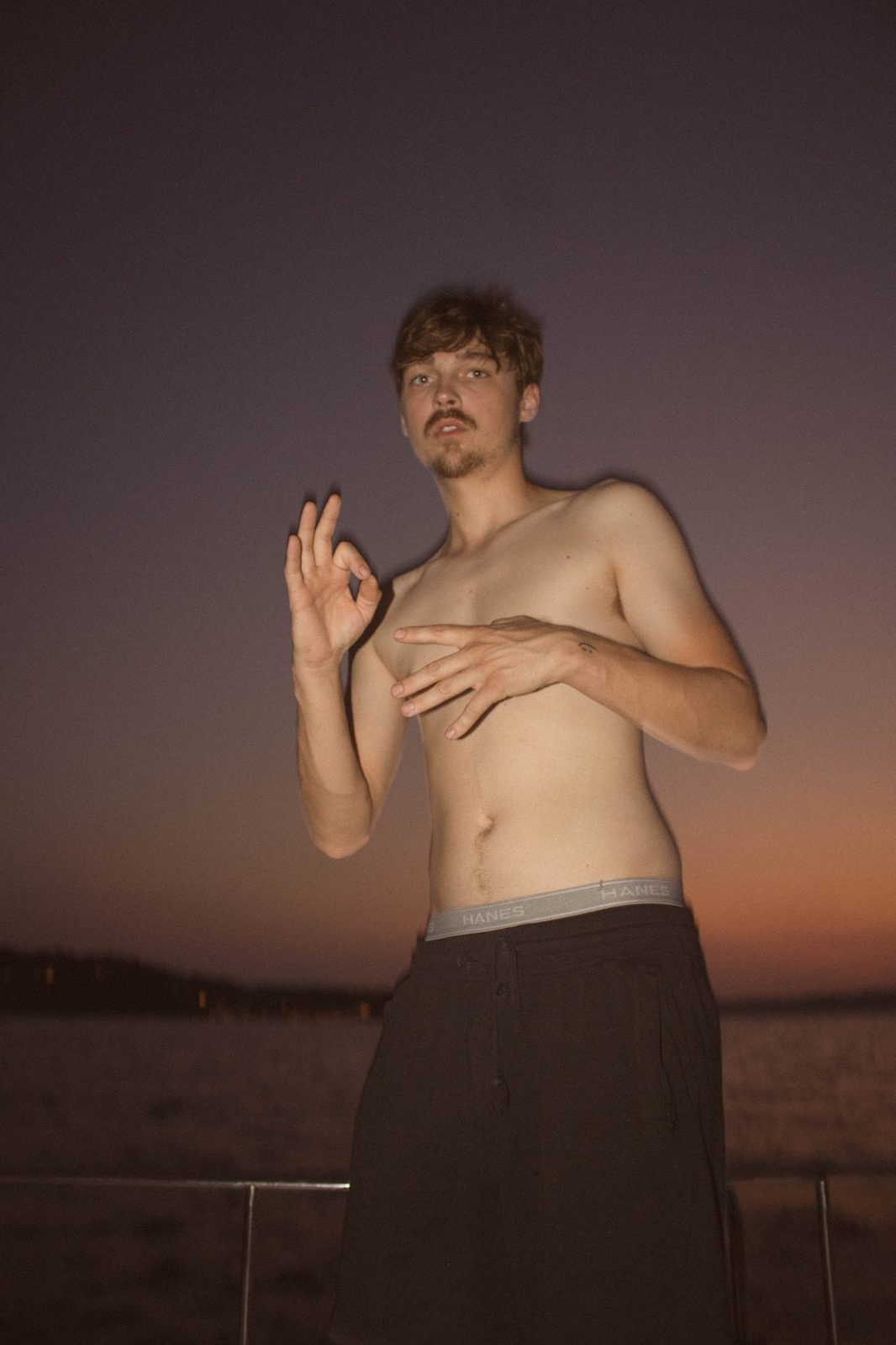 04Riley with the OK sign at dusk on the lake
