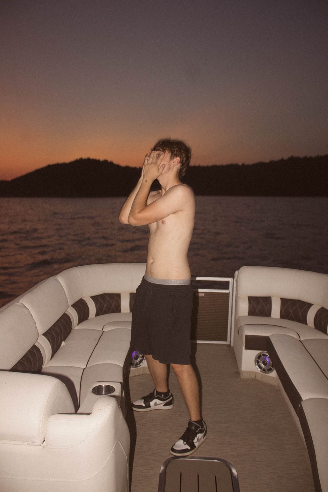 04Riley covering his face against the sunset