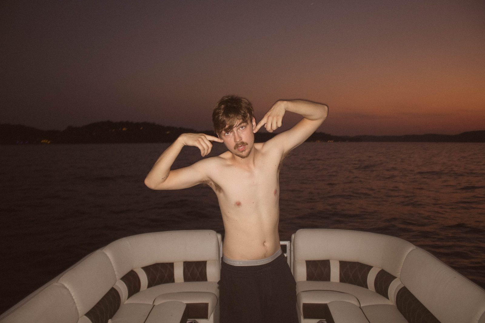04Riley pointing at the sunset behind him